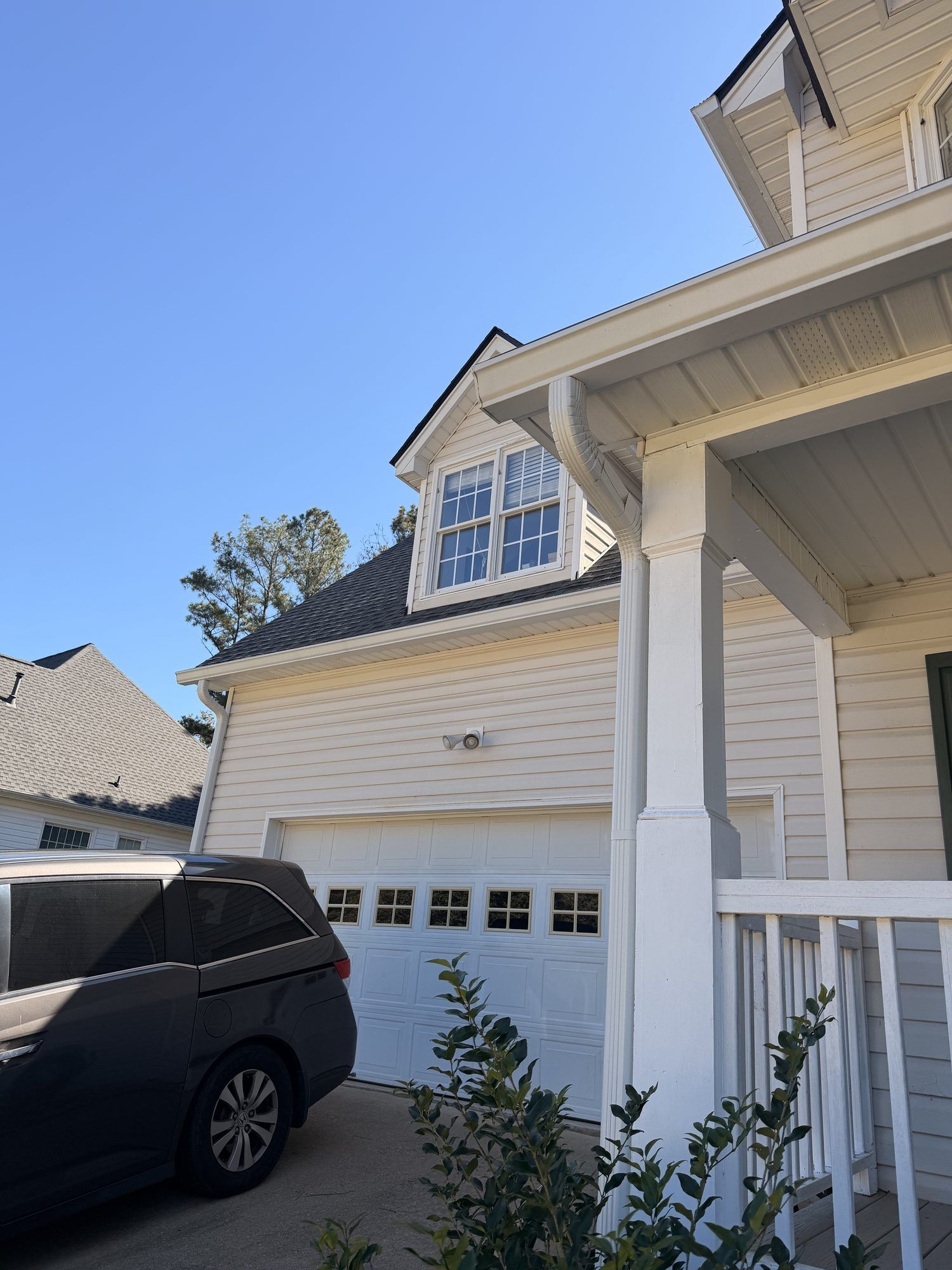 Two-story vinyl home with white gutters and downspouts in Douglasville