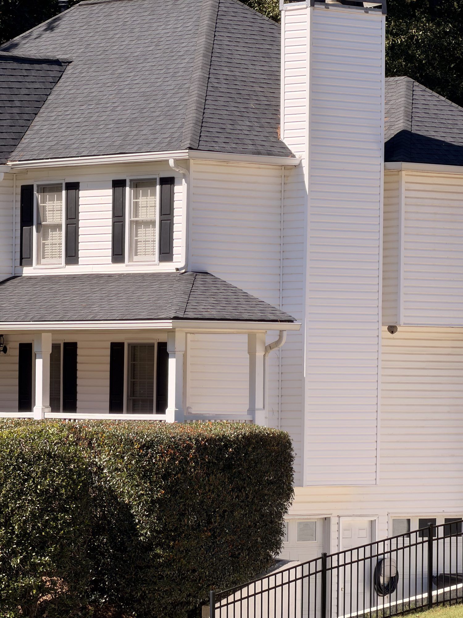 Two-story white home with gutters along every roofline in Douglasville