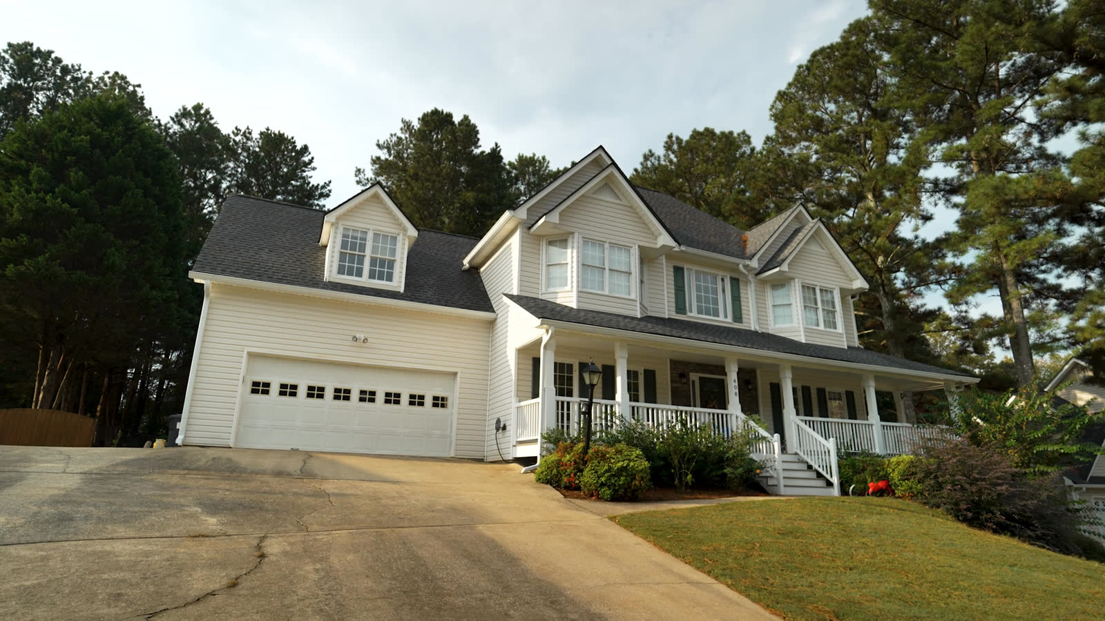 White seamless gutters on a two story home with a covered front porch